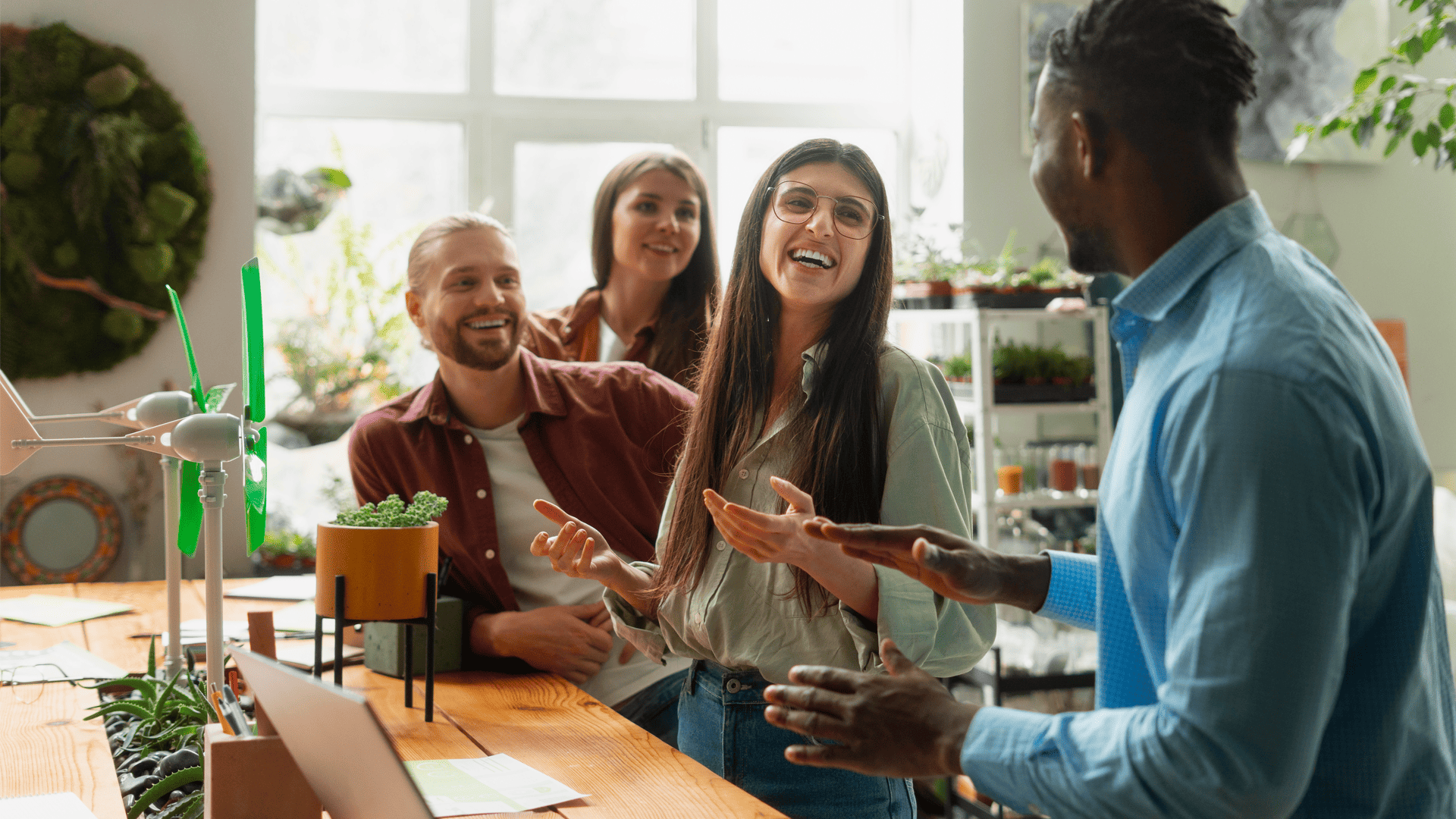 Pessoas sorrindo juntas em um ambiente de trabalho confortável que proporciona bem-estar subjetivo